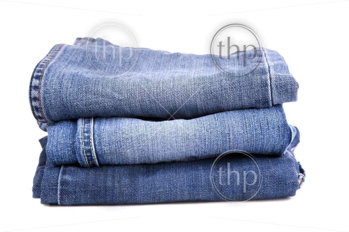 Blue jeans folded and stacked together, isolated on white - THPStock